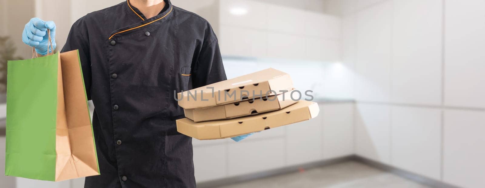 Young handsome man holding delivery paper bag.