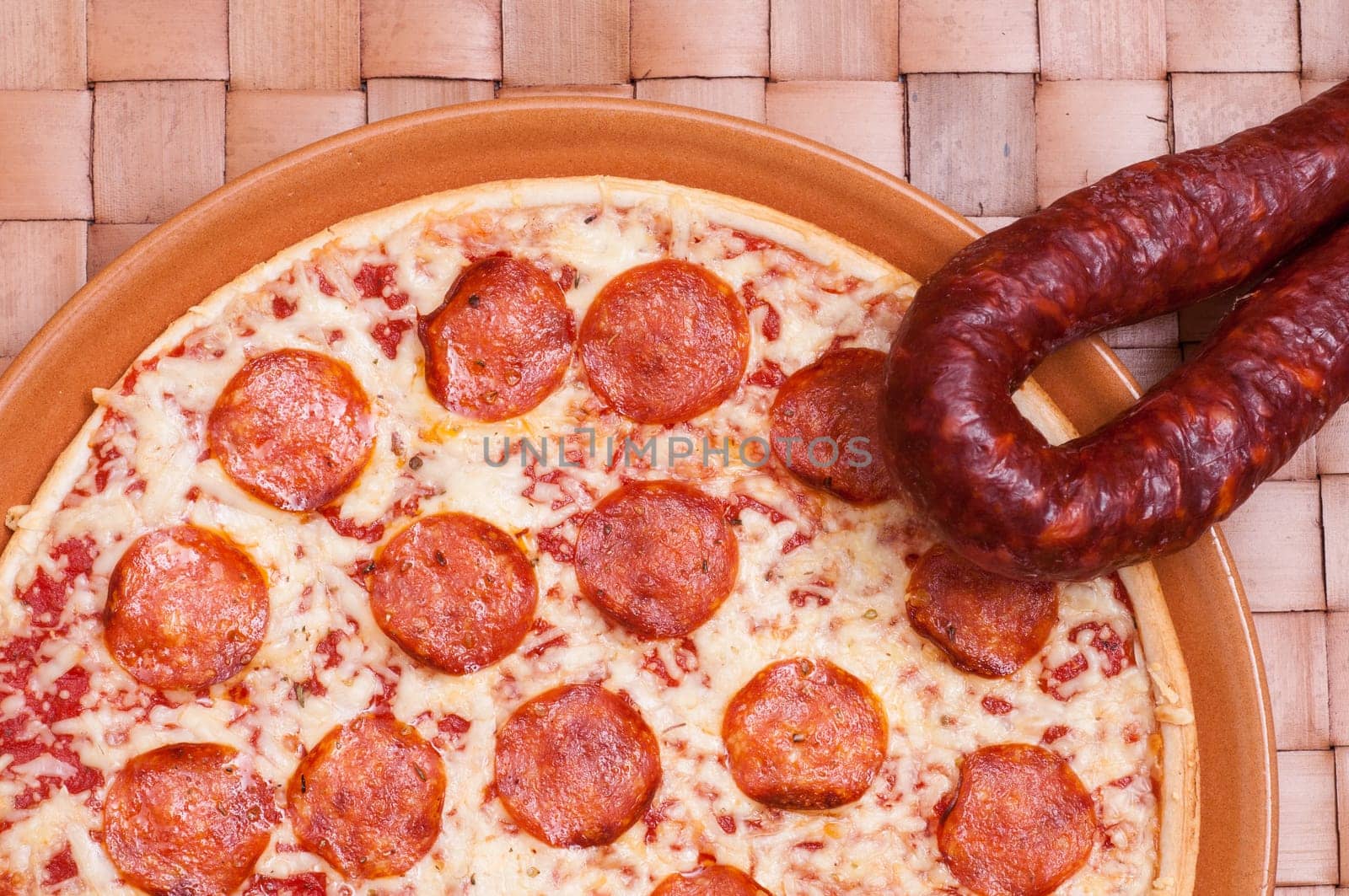 Pizza picante with spicy salami sausage,cheese and tomatoes