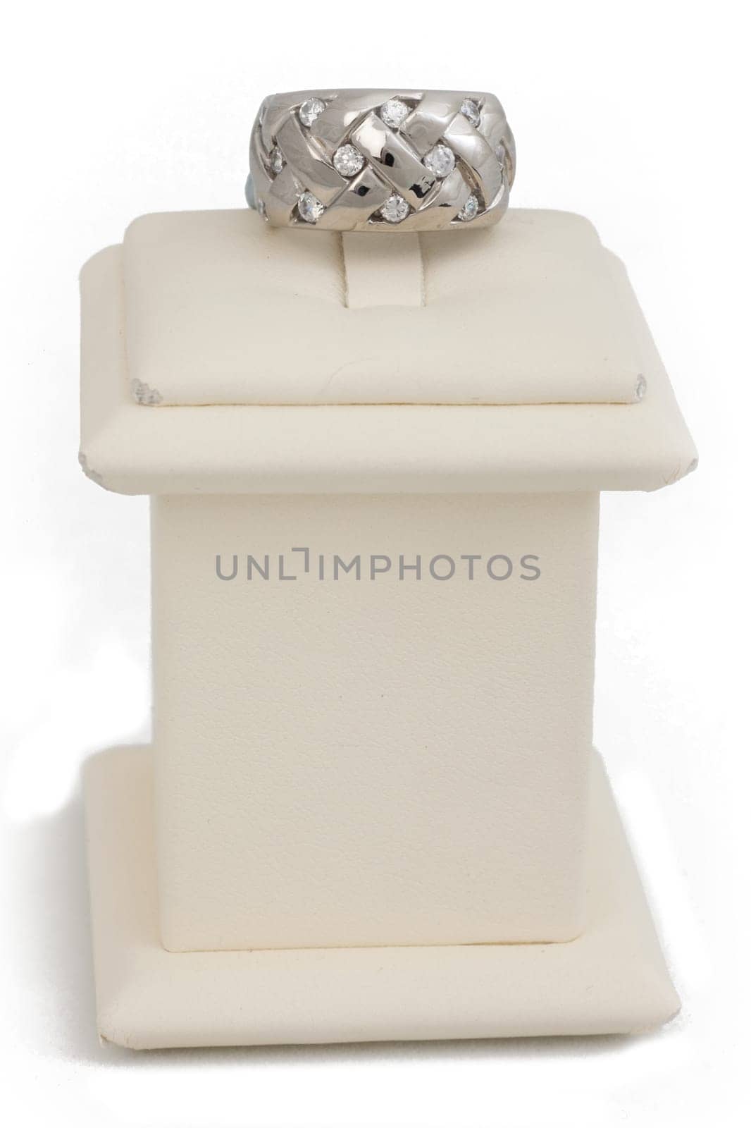 Woven ring with diamonds on display stand