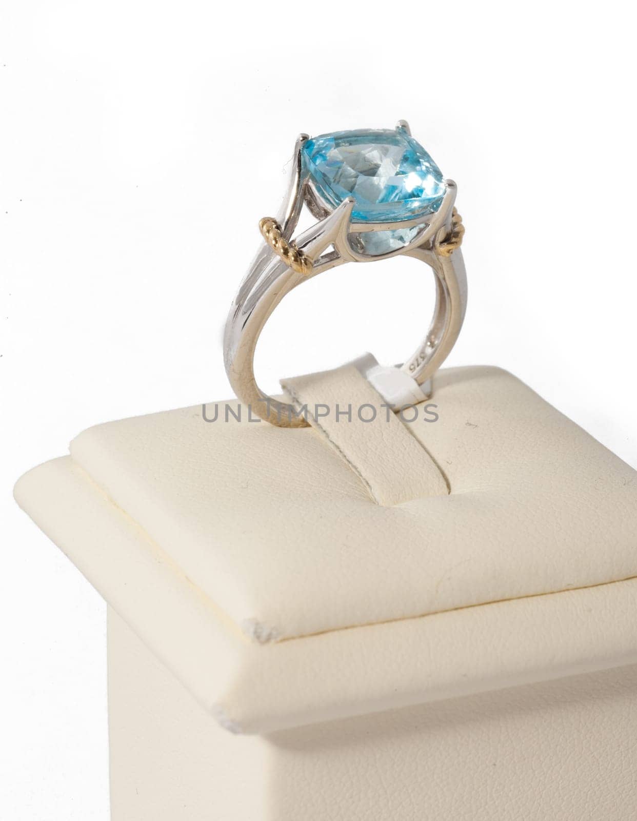 Ring with blue stone on display stand