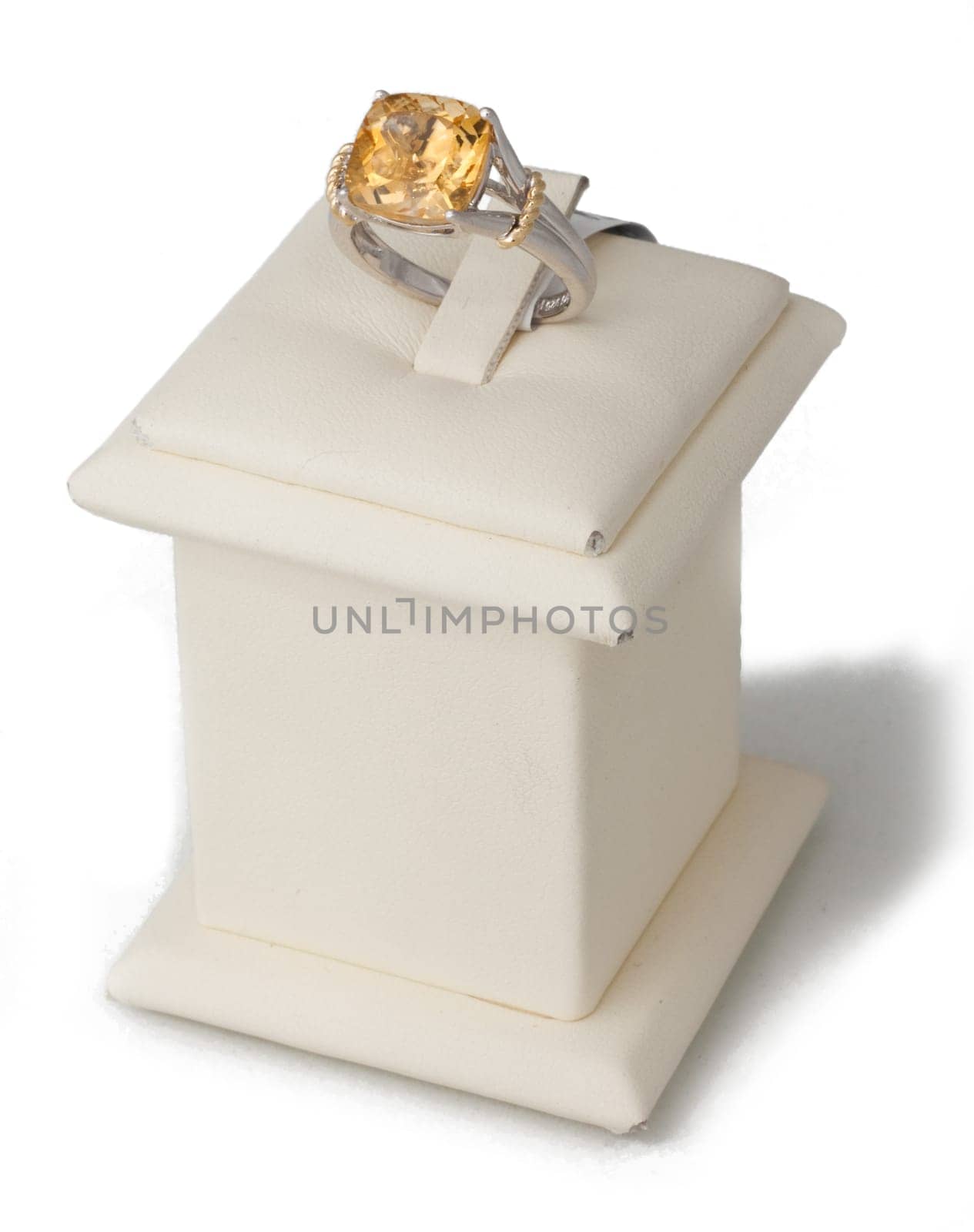 Ring with amber stone on display stand