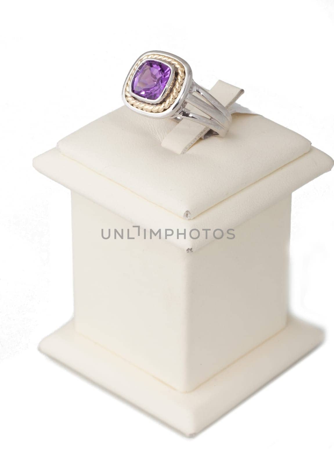 Ring with purple stone on display stand