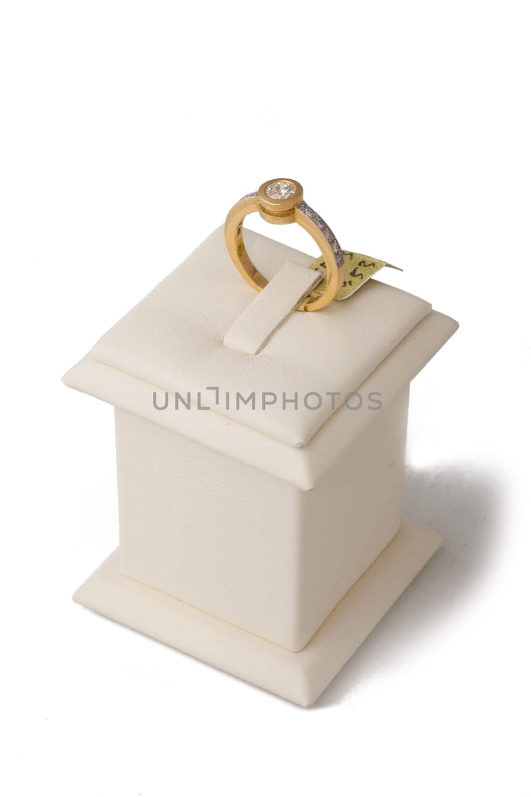Gold ring with diamonds on display stand