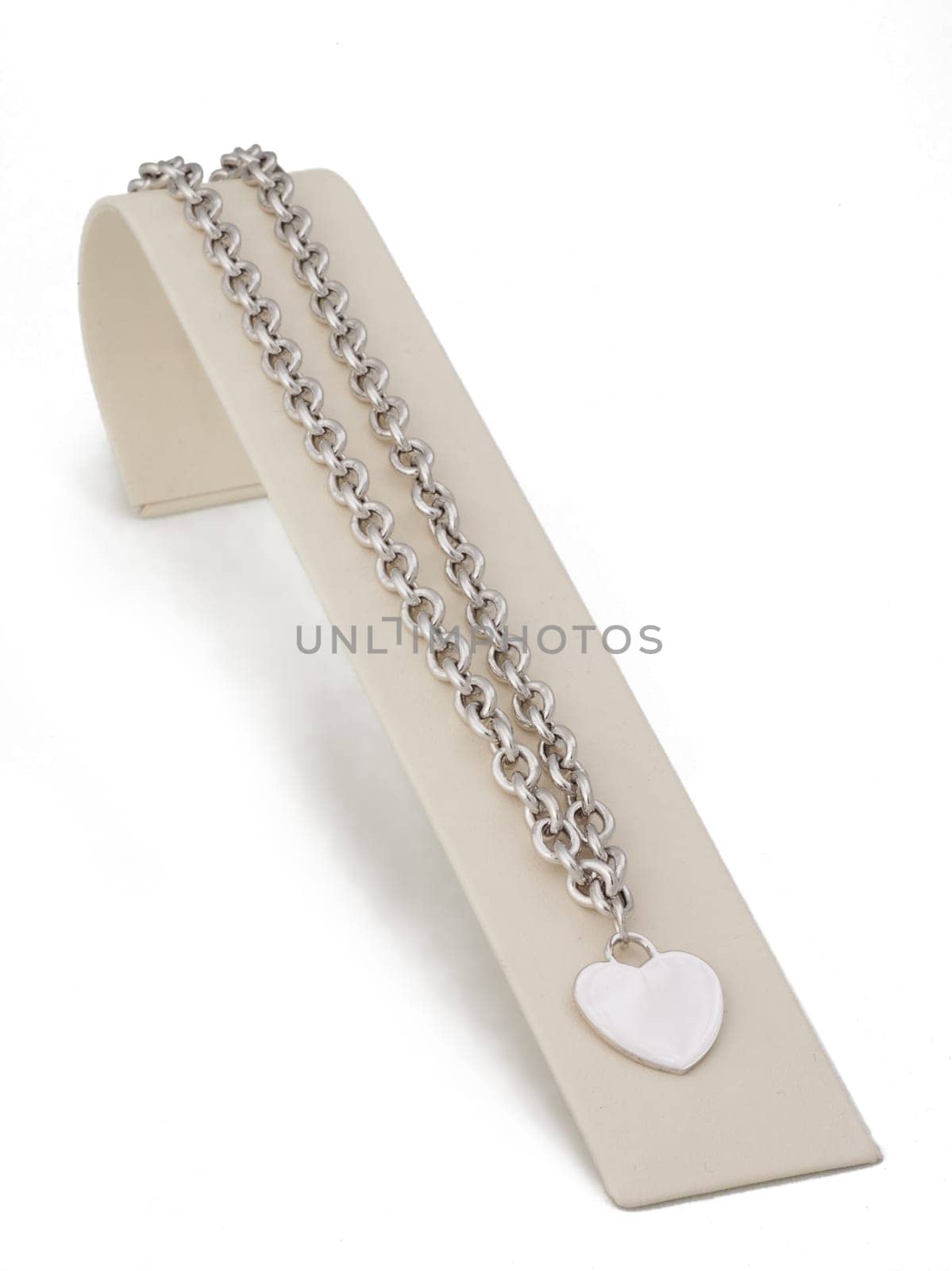 Silver chain heart necklace on display stand