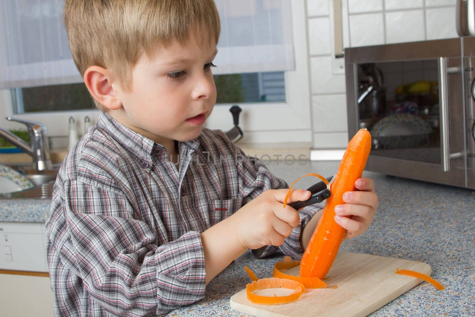 Child peeling carrots