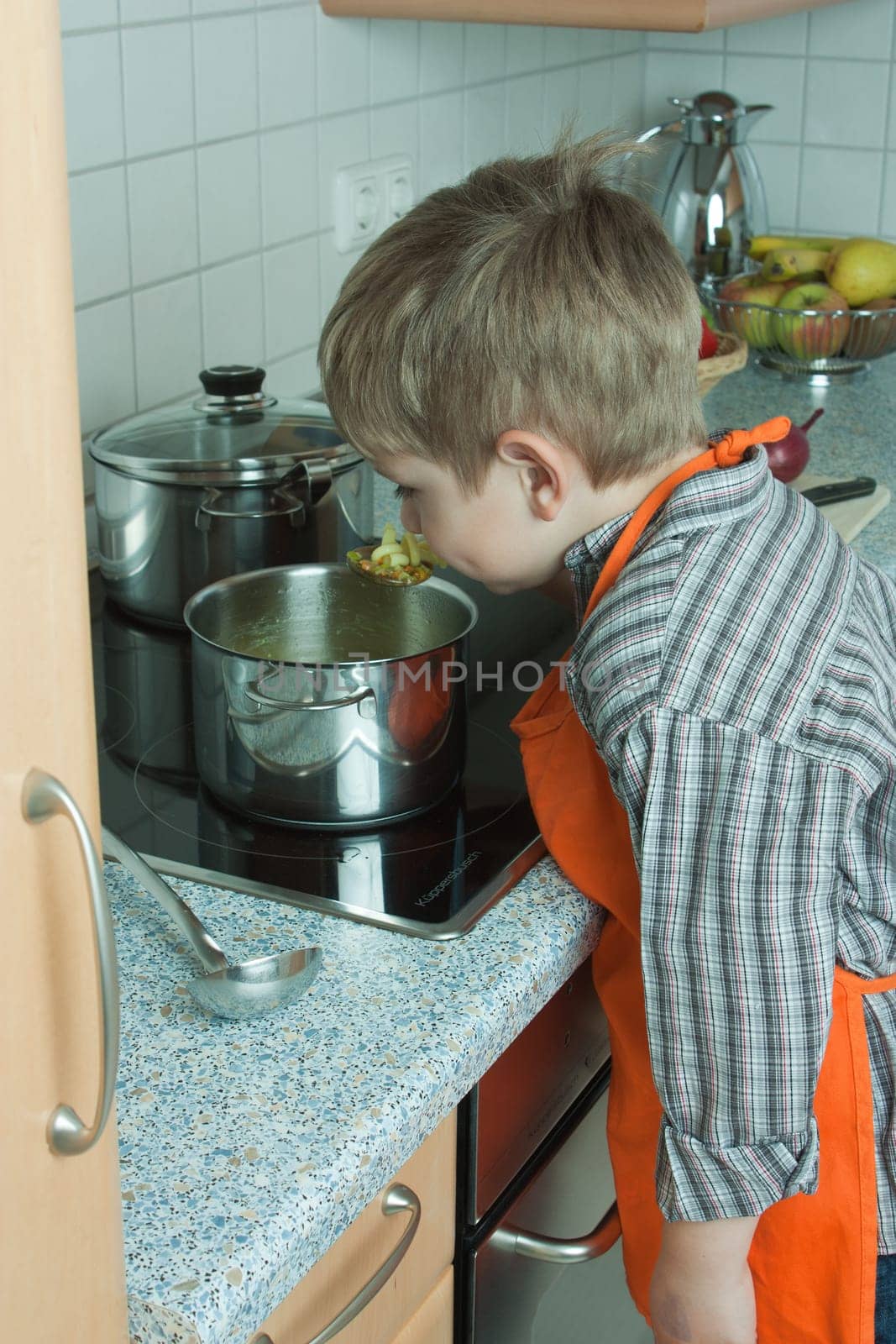 Boy cooking soup