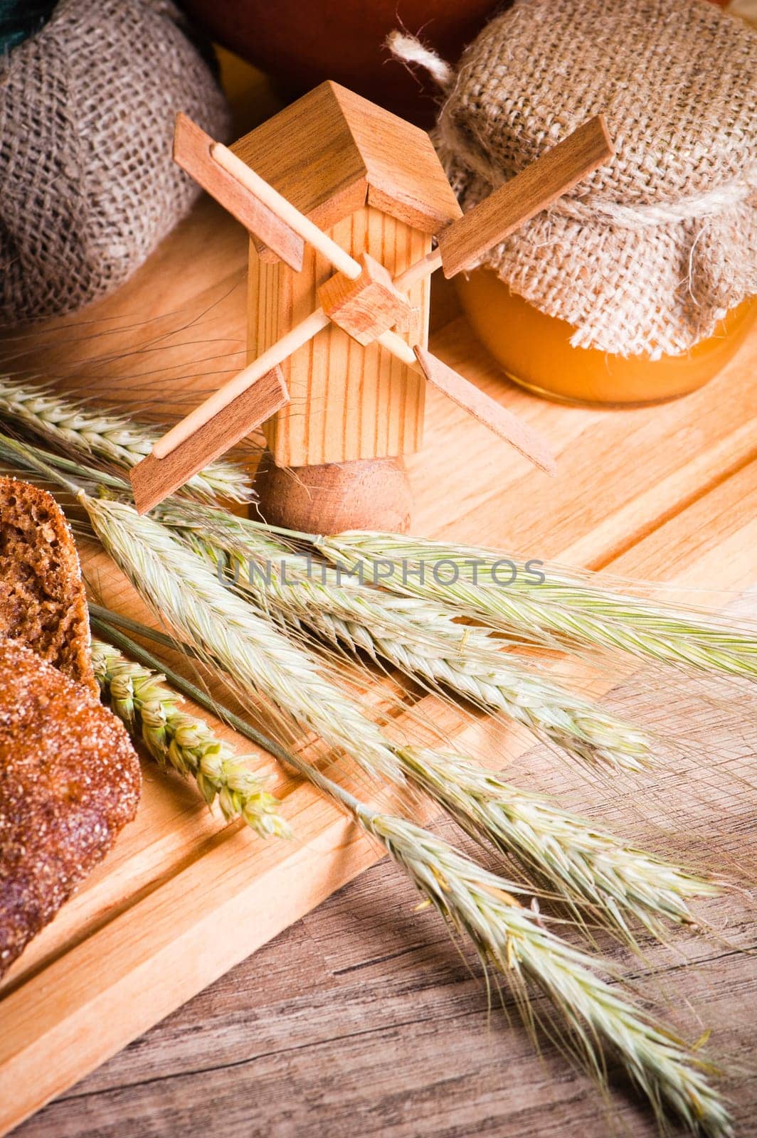 sliced bread and wheat on the wooden table