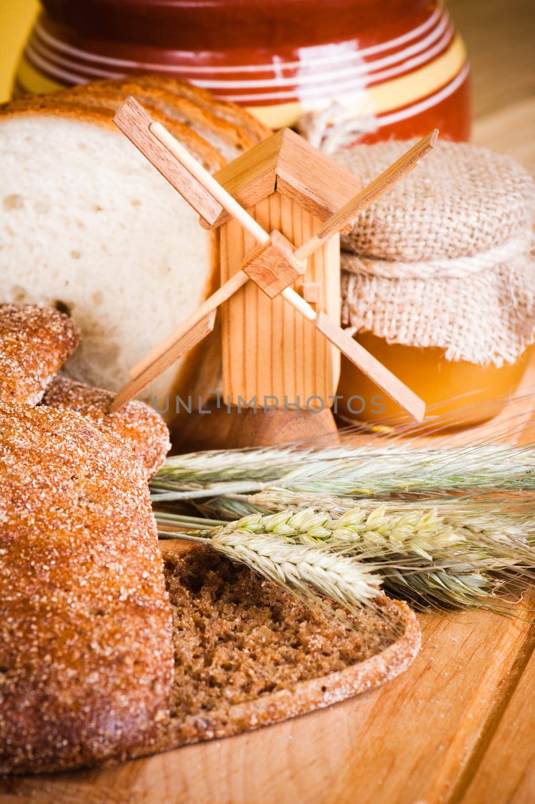 sliced bread and wheat on the wooden table