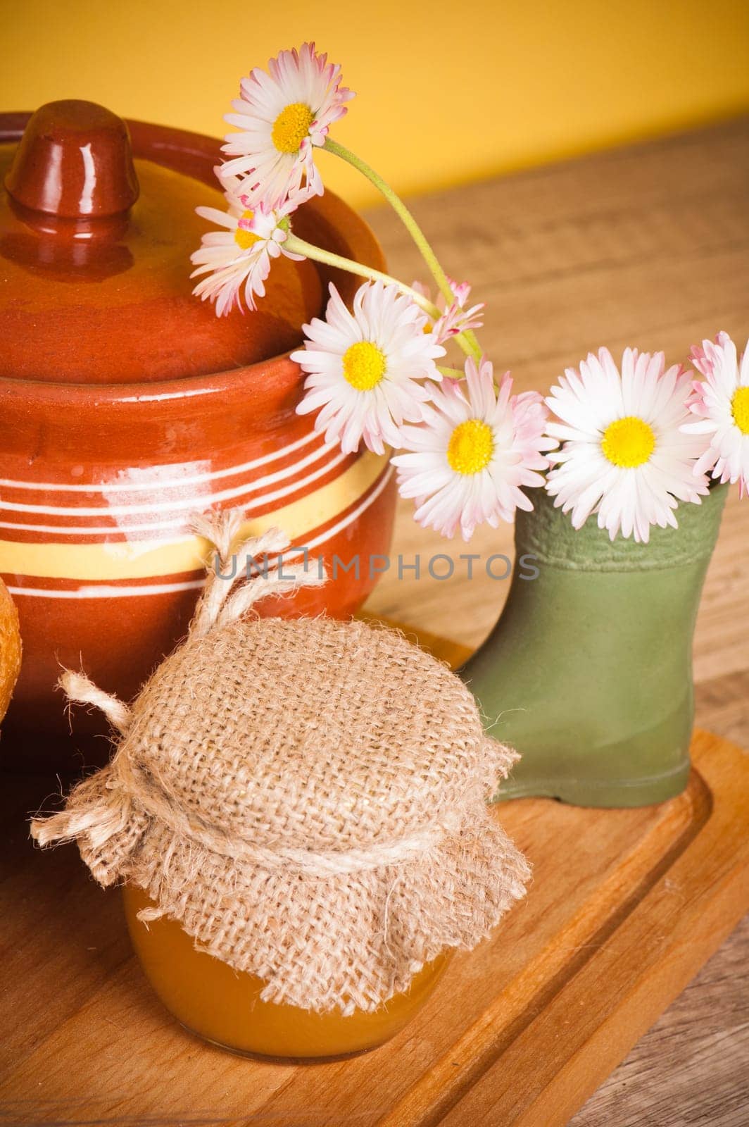 Still life with honey, flowers and pot