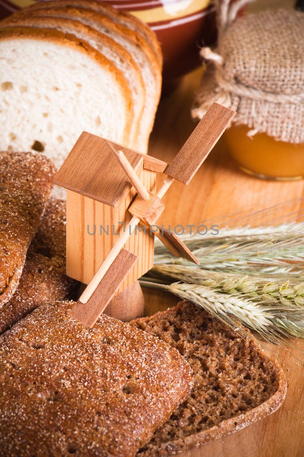 sliced bread and wheat on the wooden table