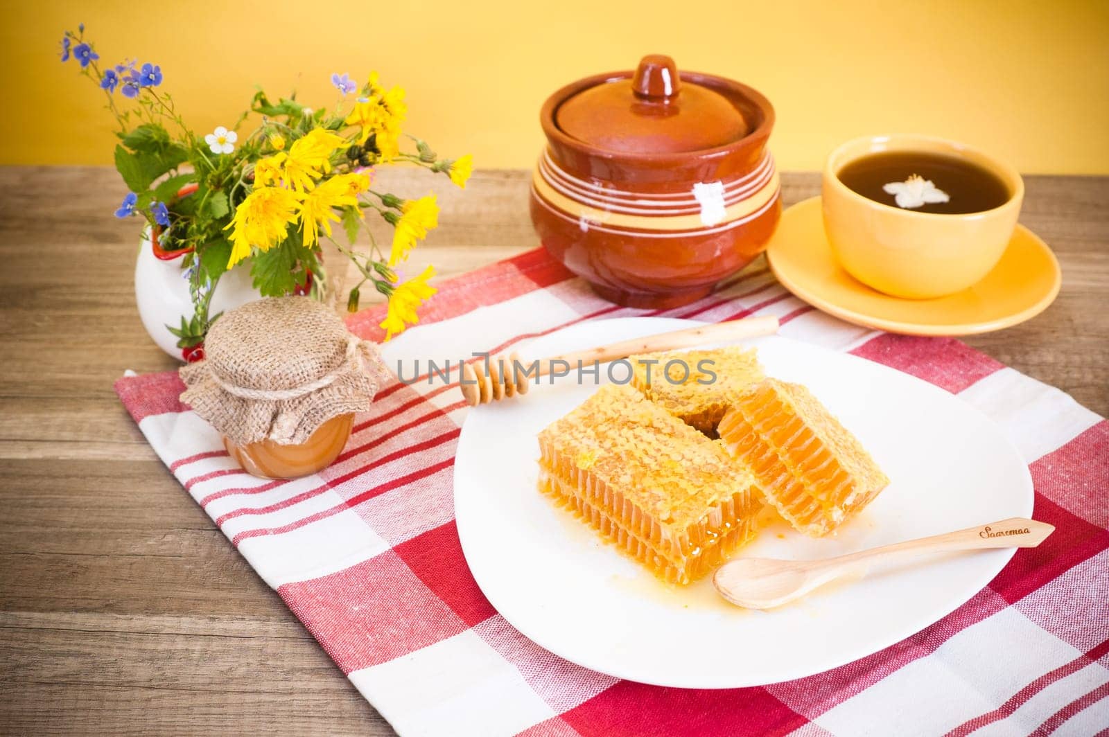 Still life with honeycombs, flowers and pot