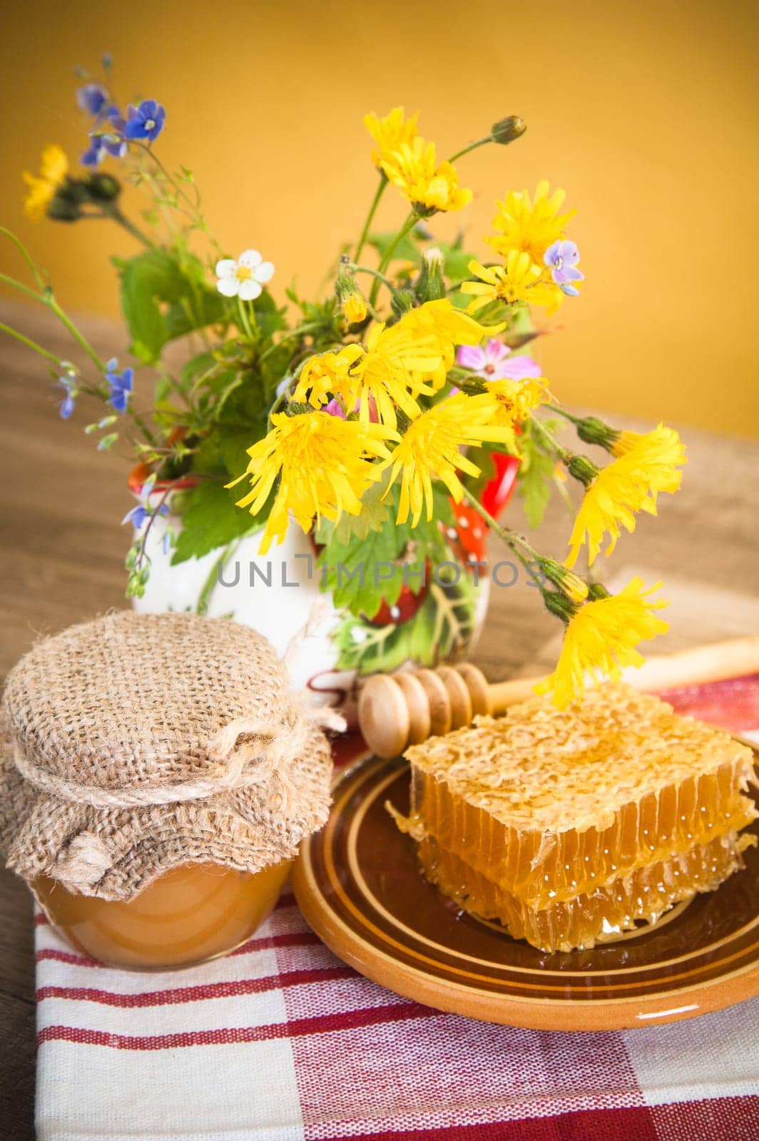 Still life with honeycombs, flowers and pot