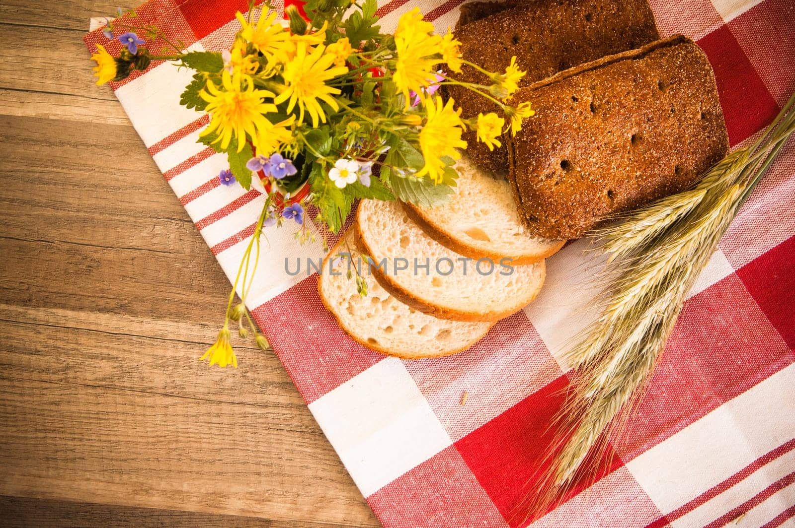 Still life with bread, flowers and spikes