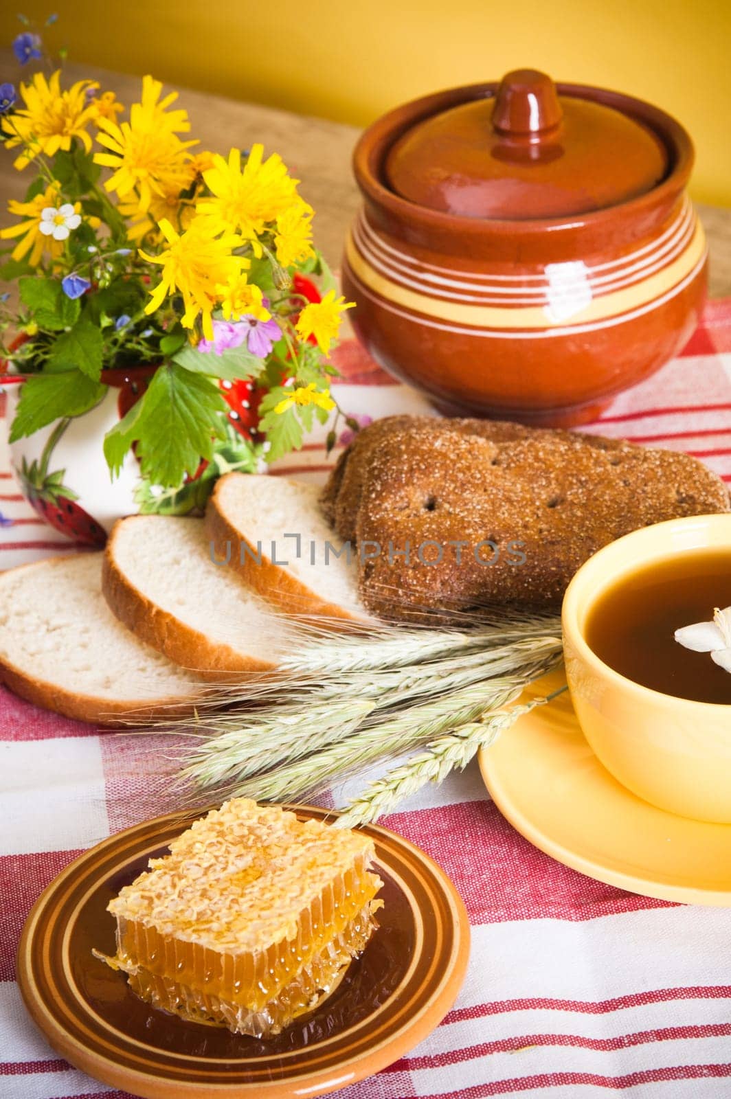 Still life with honeycombs, flowers and pot