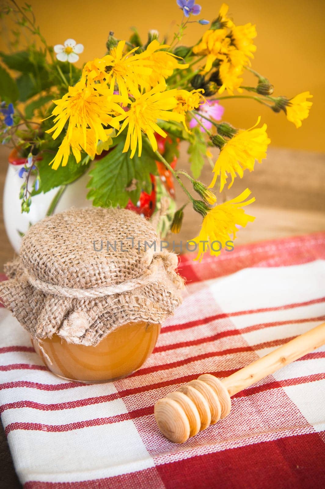 Still life with honeycombs, flowers and pot