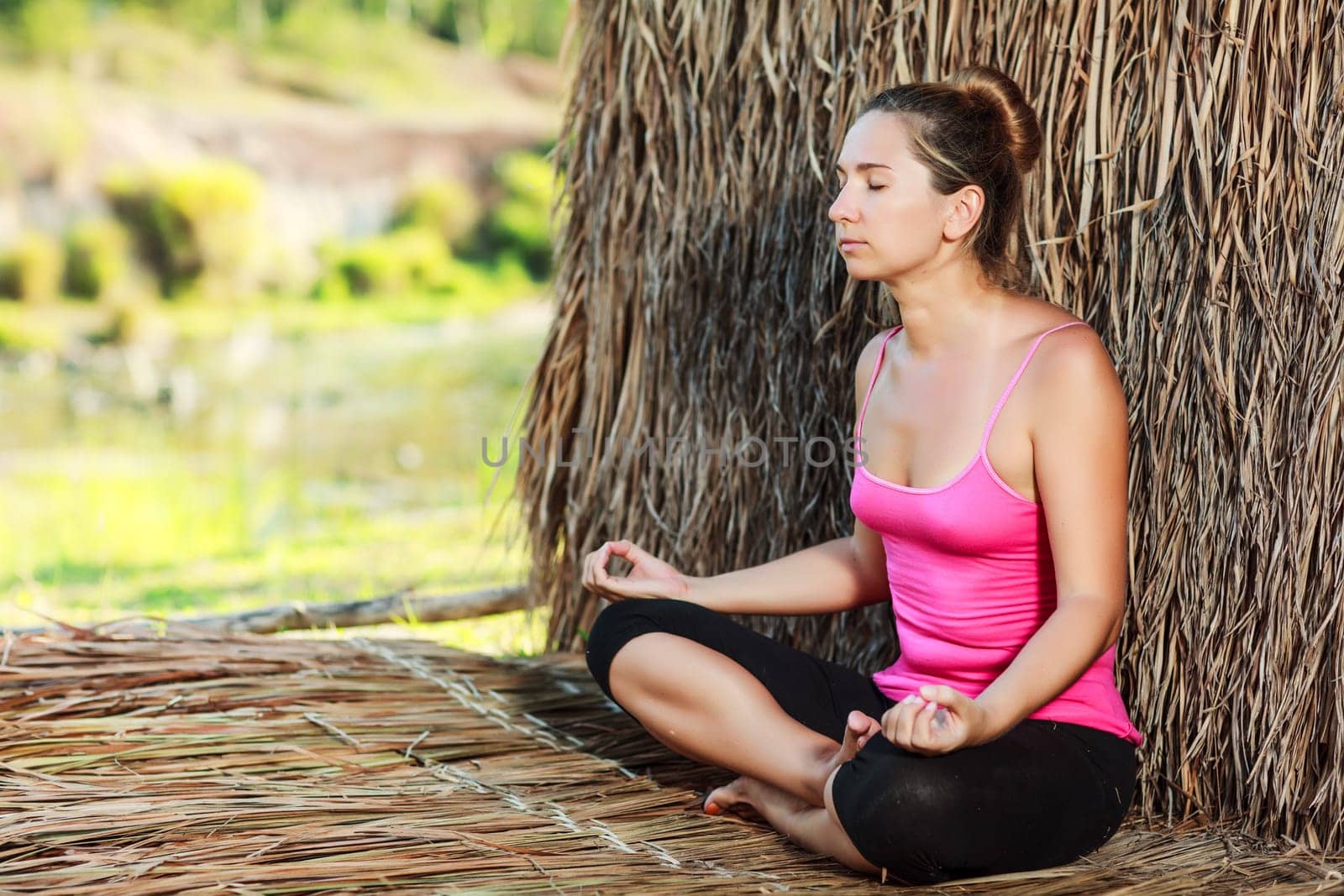 Beautiful young woman doing yoga exercises