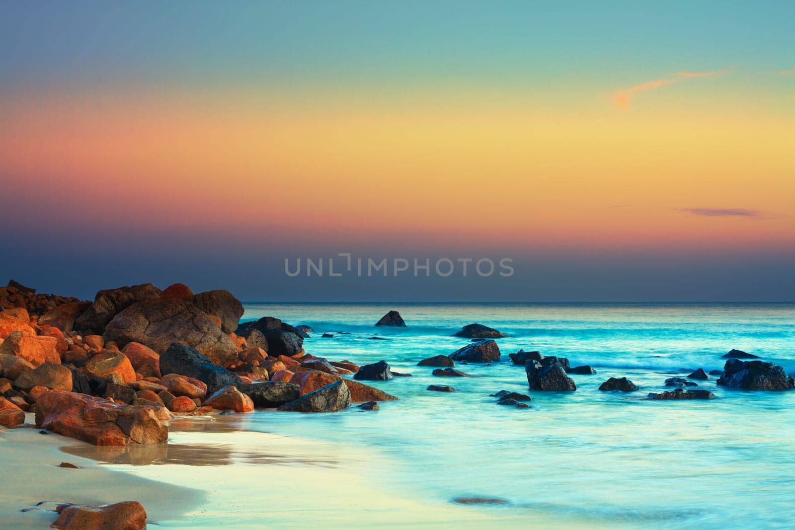 Sunset over the sea. Stone on the foreground