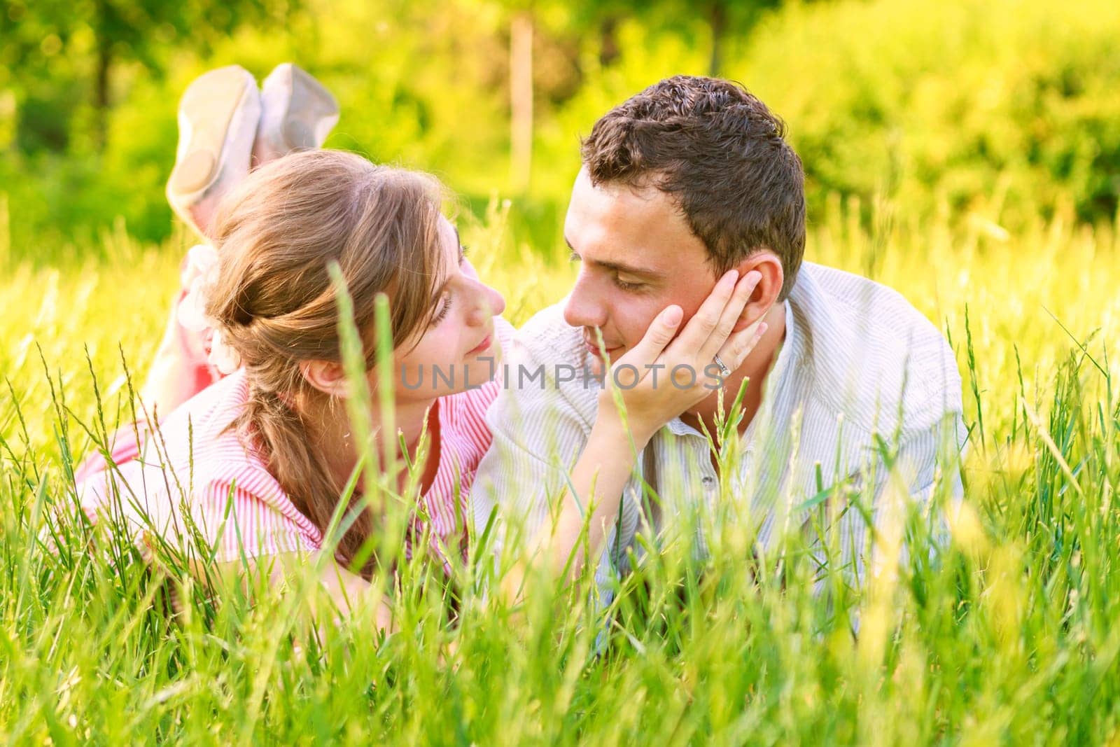 Close-up of a young couple in love on grass