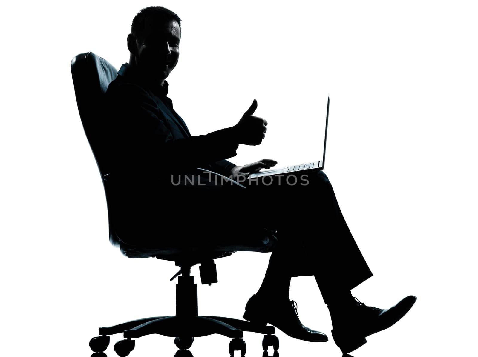 one caucasian business man computer computing thumb up sitting in armchair silhouette Full length in studio isolated on white background