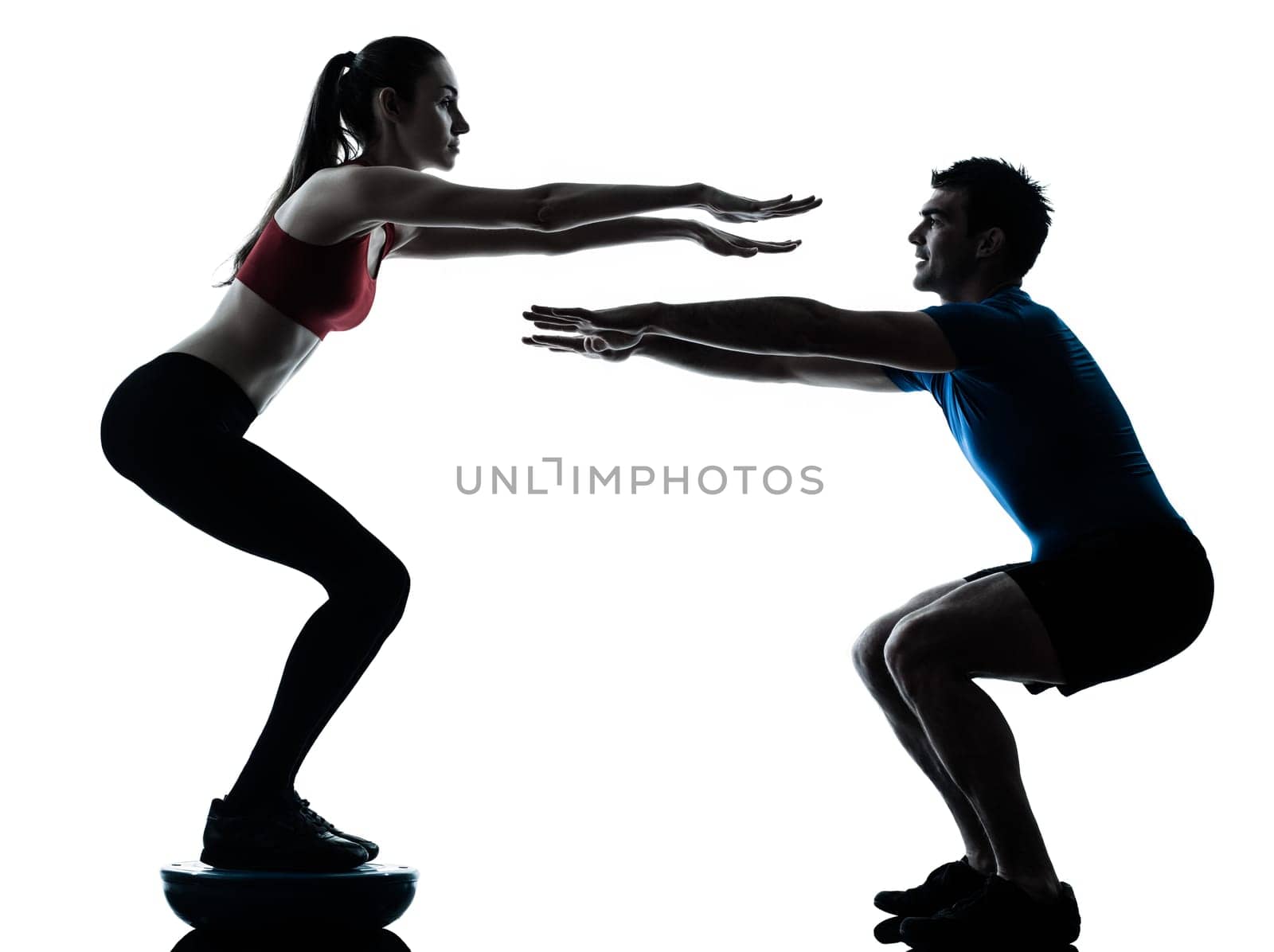 personal trainer man coach and woman exercising squats on bosu silhouette  studio isolated on white background