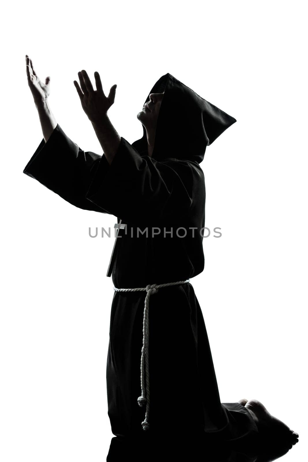 one caucasian man priest praying silhouette in studio isolated on white background