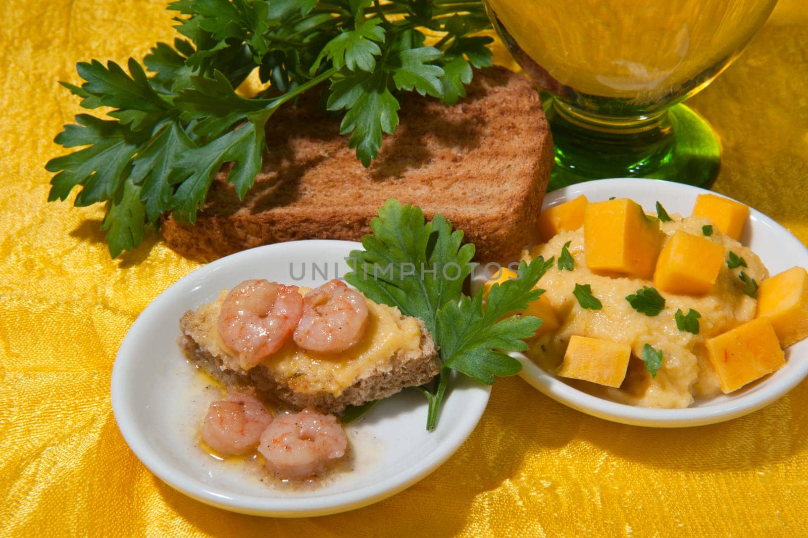 cream of pumpkin and shrimp with nutmeg and parsley on a colored background