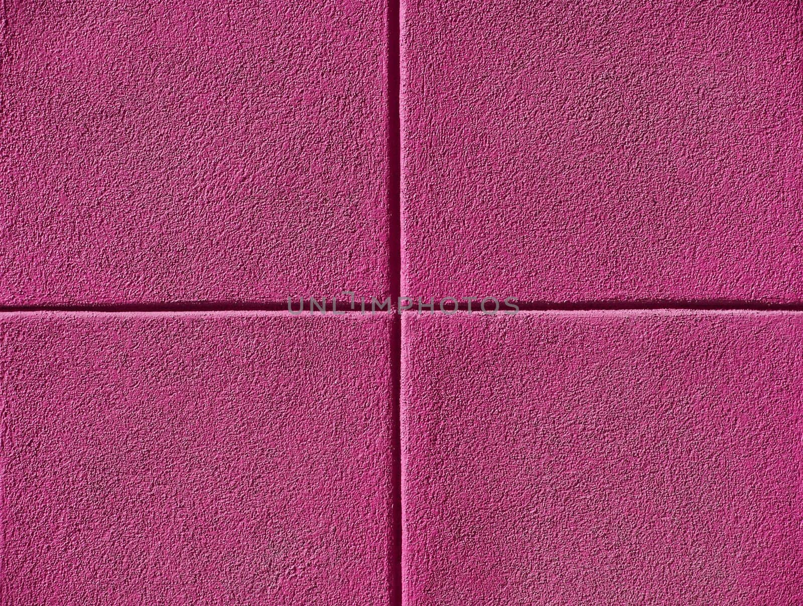 Four pink squares on a concrete wall, powerpoint background and copy space.