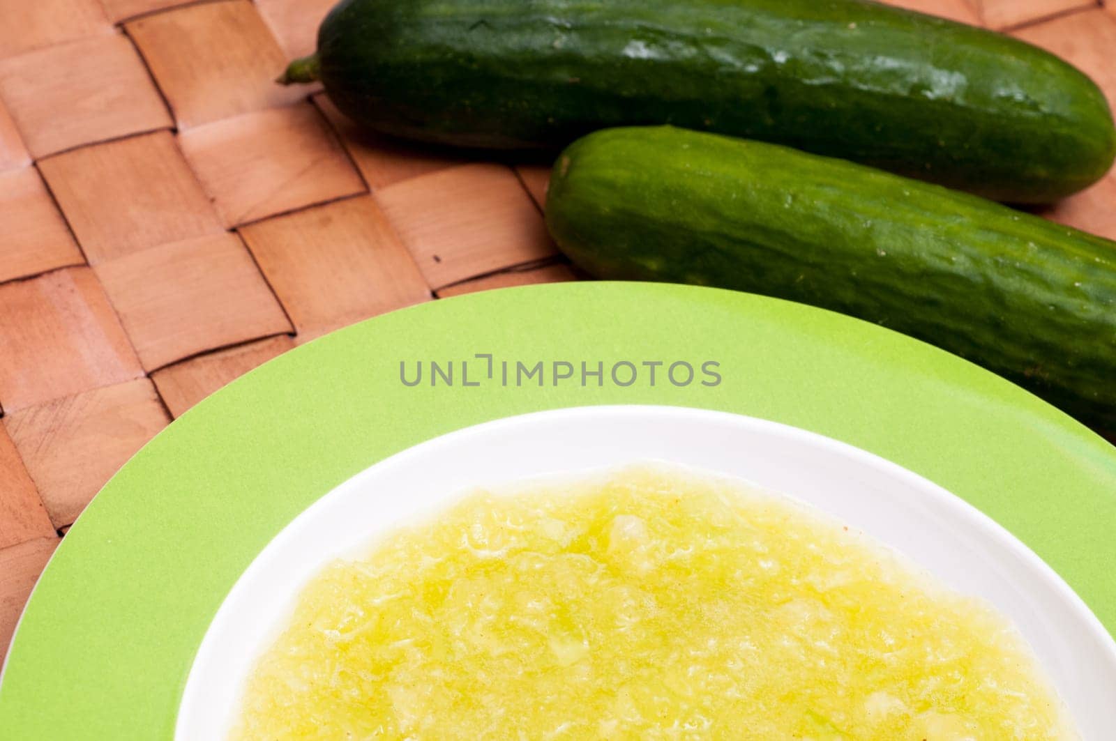 Cold soup in a plate with cucumbers