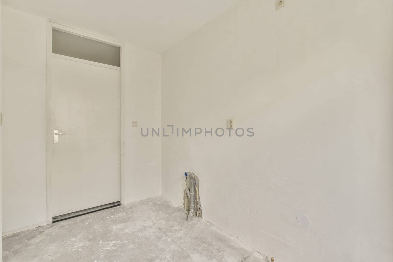 an unfinished room with white paint on the walls and door to the other rooms in the room is being renovated