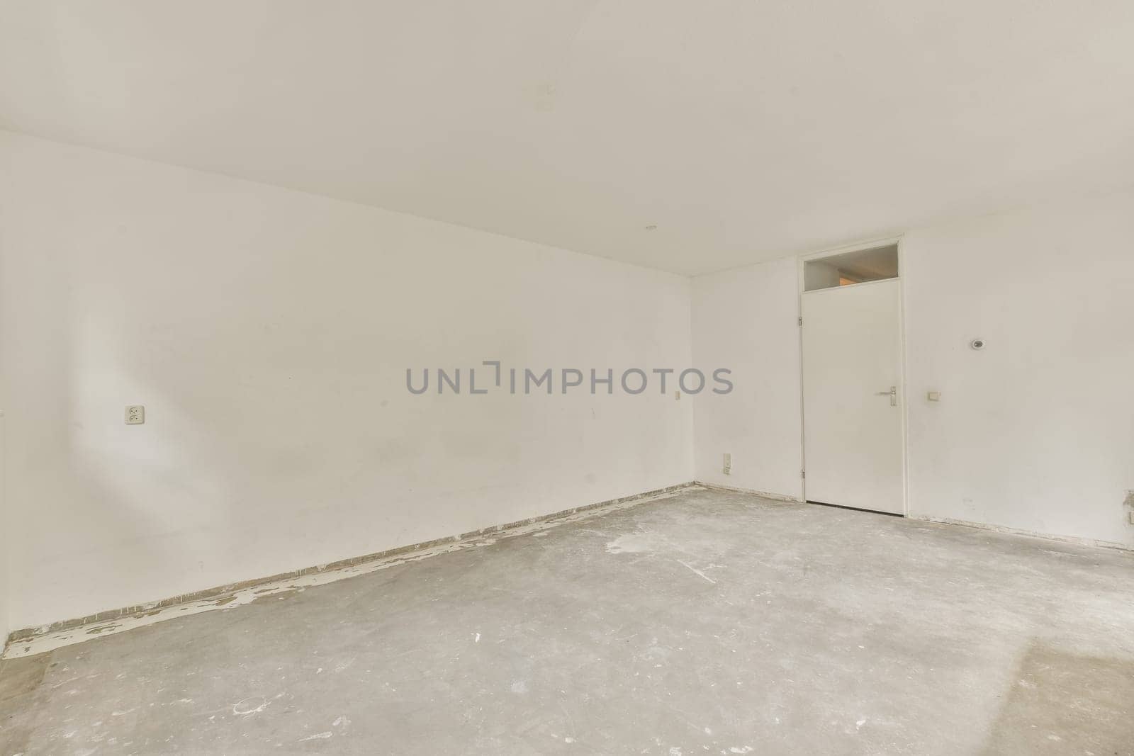 an empty room with white walls and no one door on the other wall in it is being used for storage