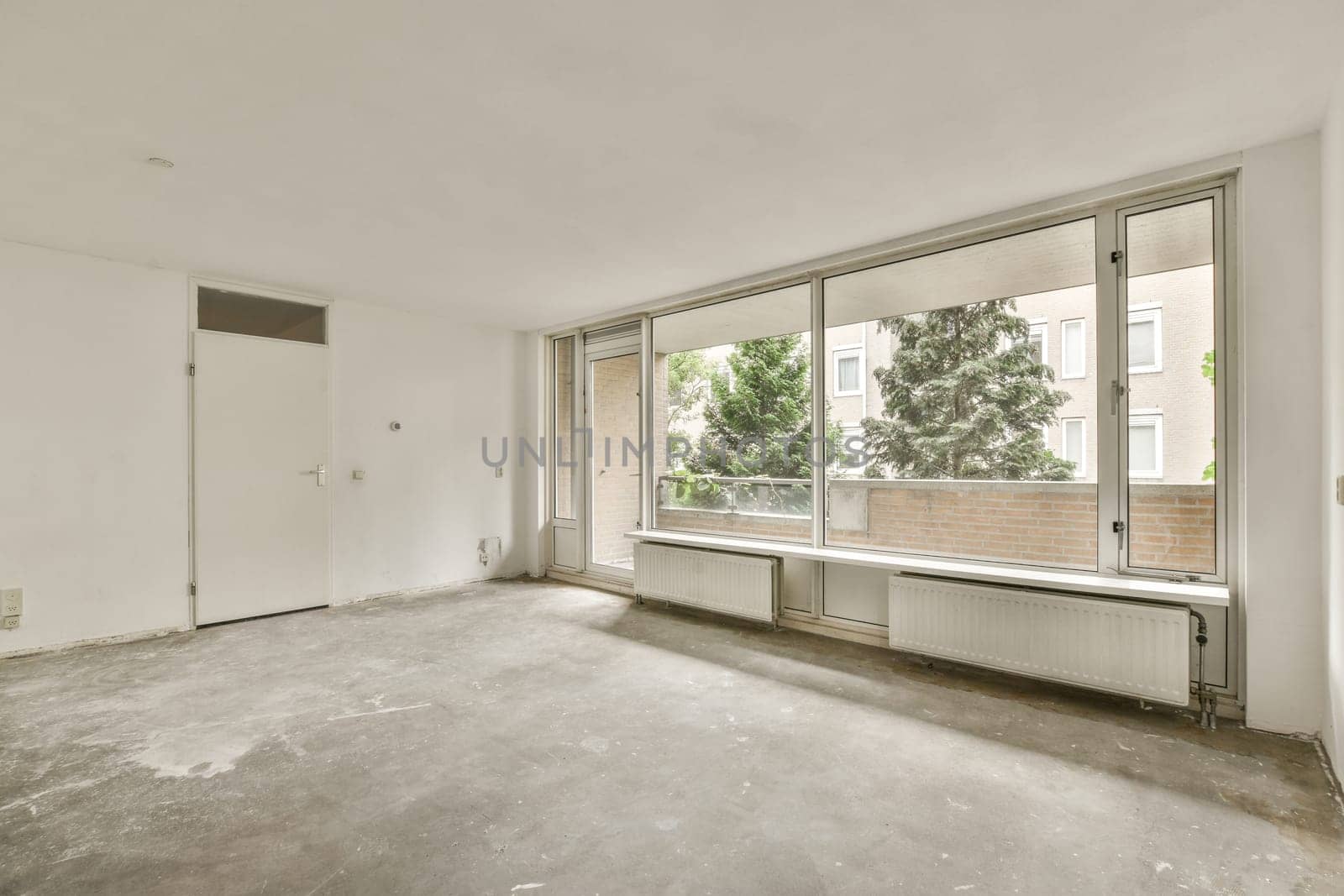 an empty room with a large window and a door by casamedia