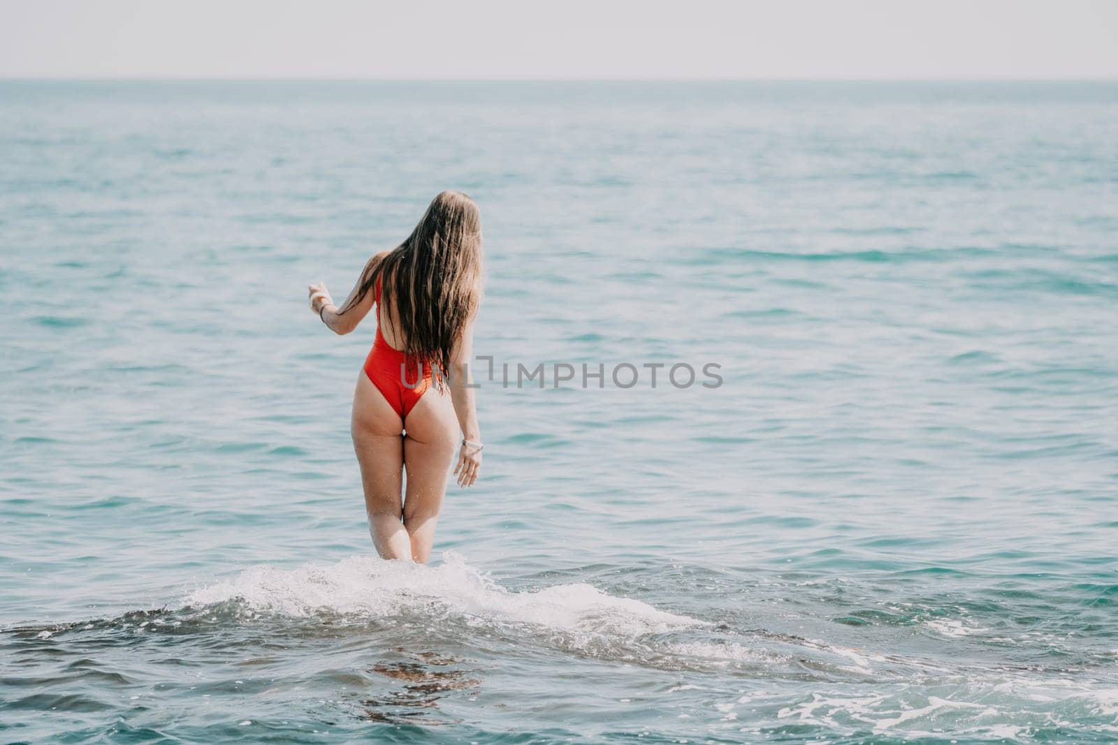 Woman sea yoga. Back view of free calm happy satisfied woman with long hair standing on top rock with yoga position against of sky by the sea. Healthy lifestyle outdoors in nature, fitness concept by panophotograph