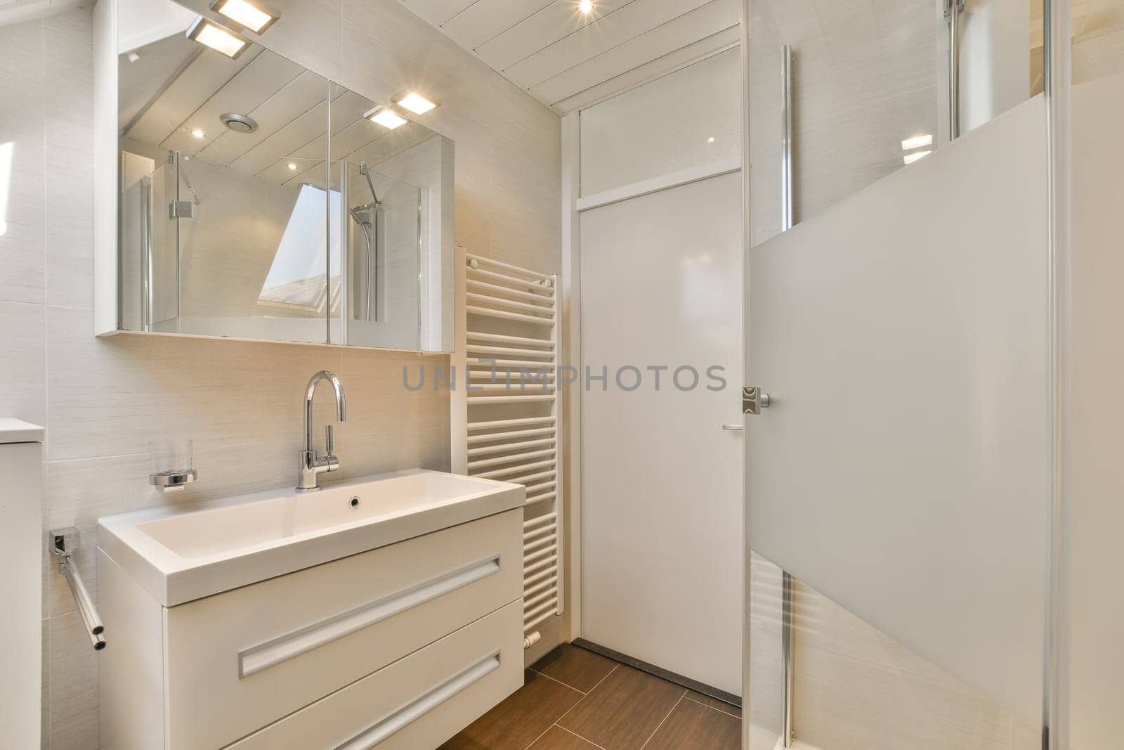 a bathroom with a sink and mirror on the wall next to it is an open door that leads to a walk - in shower