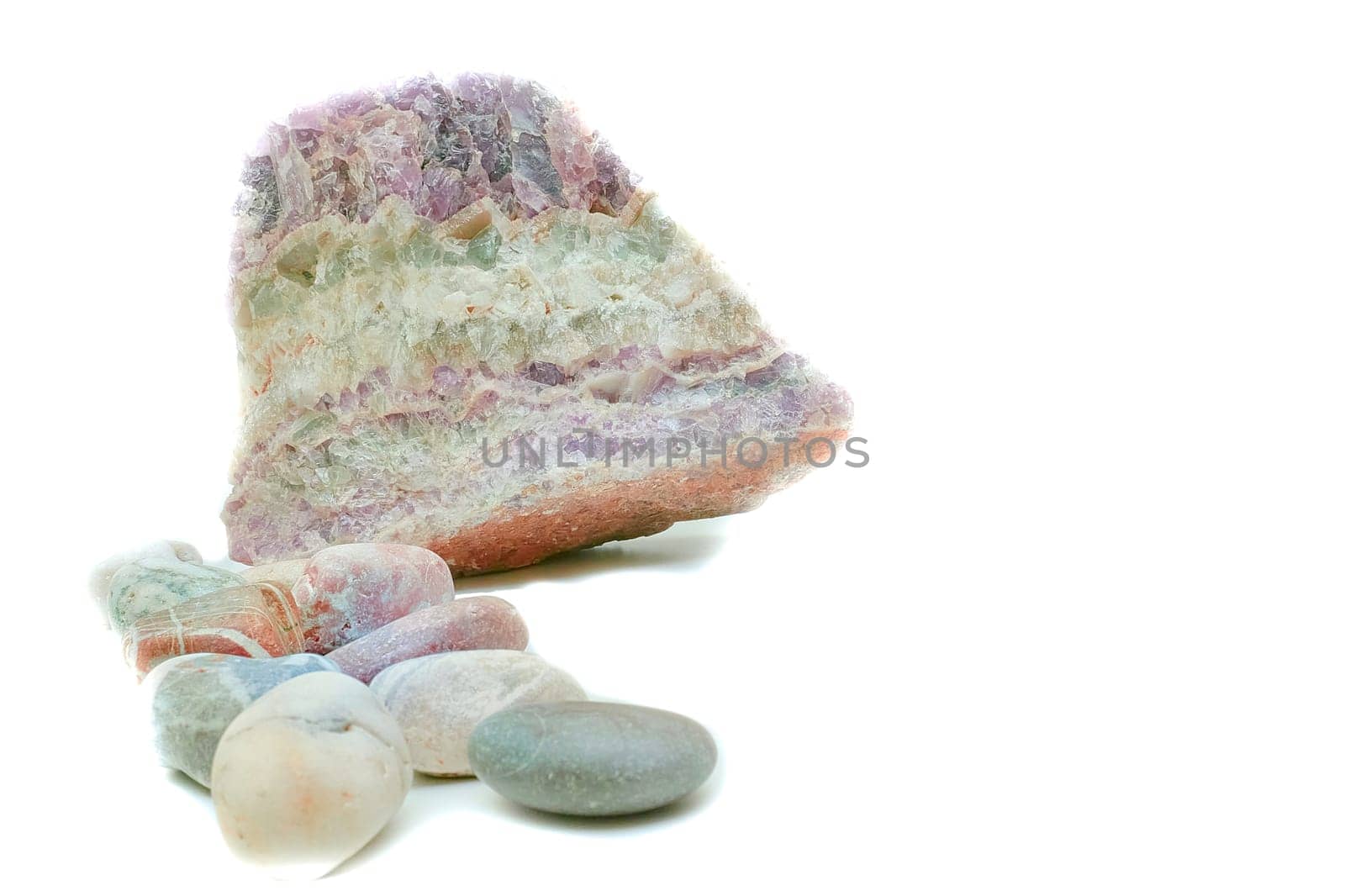Multicolored layered quartz and sea pebble stones on white by jovani68