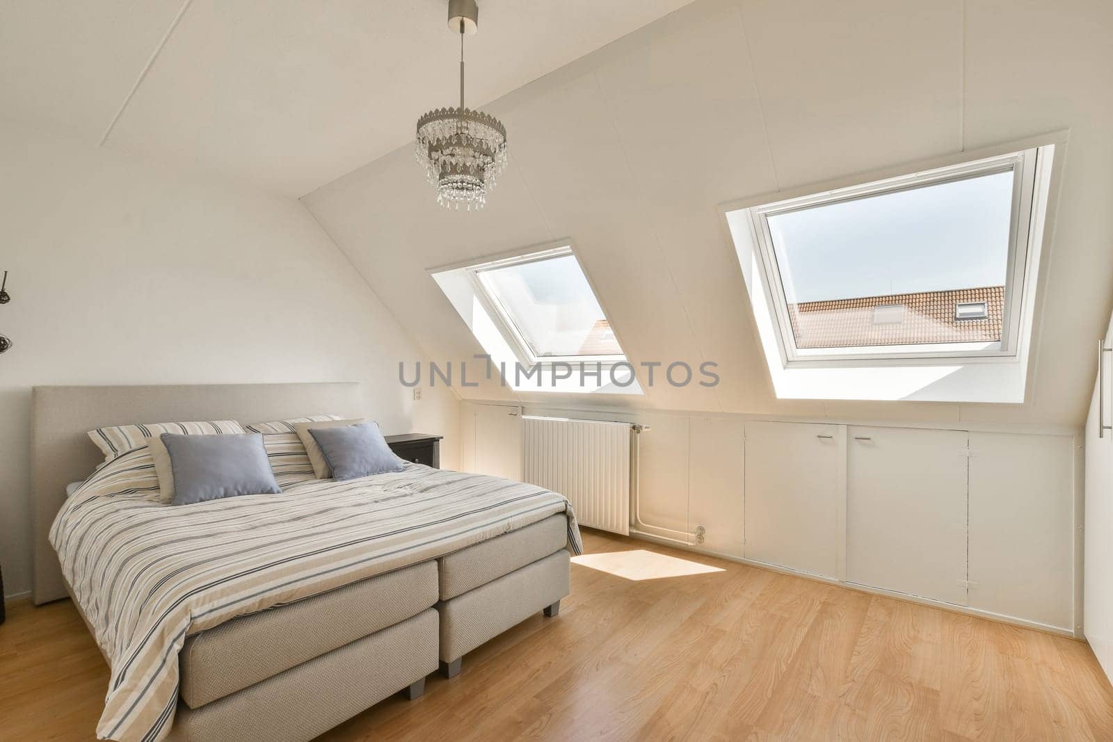 a bed in a room with skylights on the roof and wood flooring around it, as well as possible