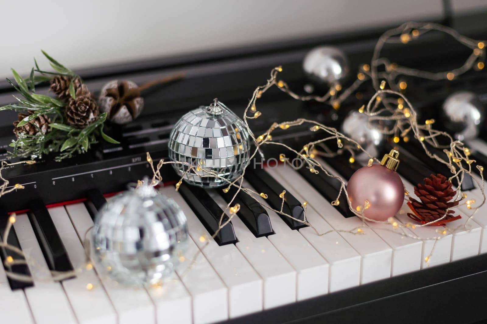Piano keyboard with Christmas decoration, closeup