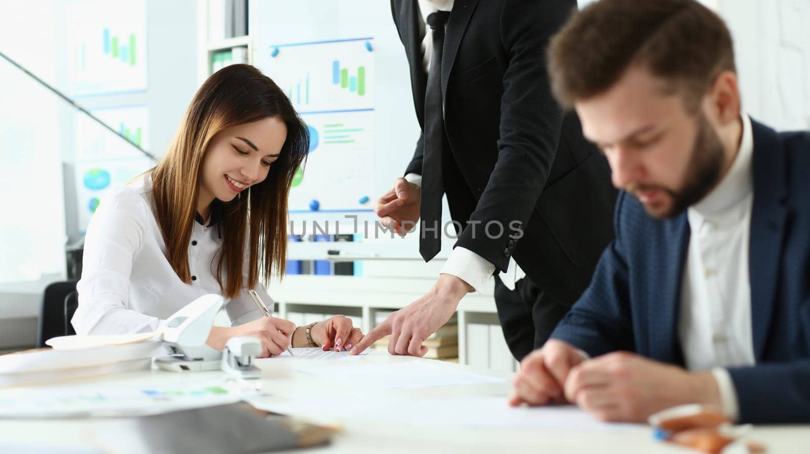 Portrait of attractive business partner discussing conditions of complicated contract. Corporate man pointing at something and explaining every detail of agreement. Company meeting concept
