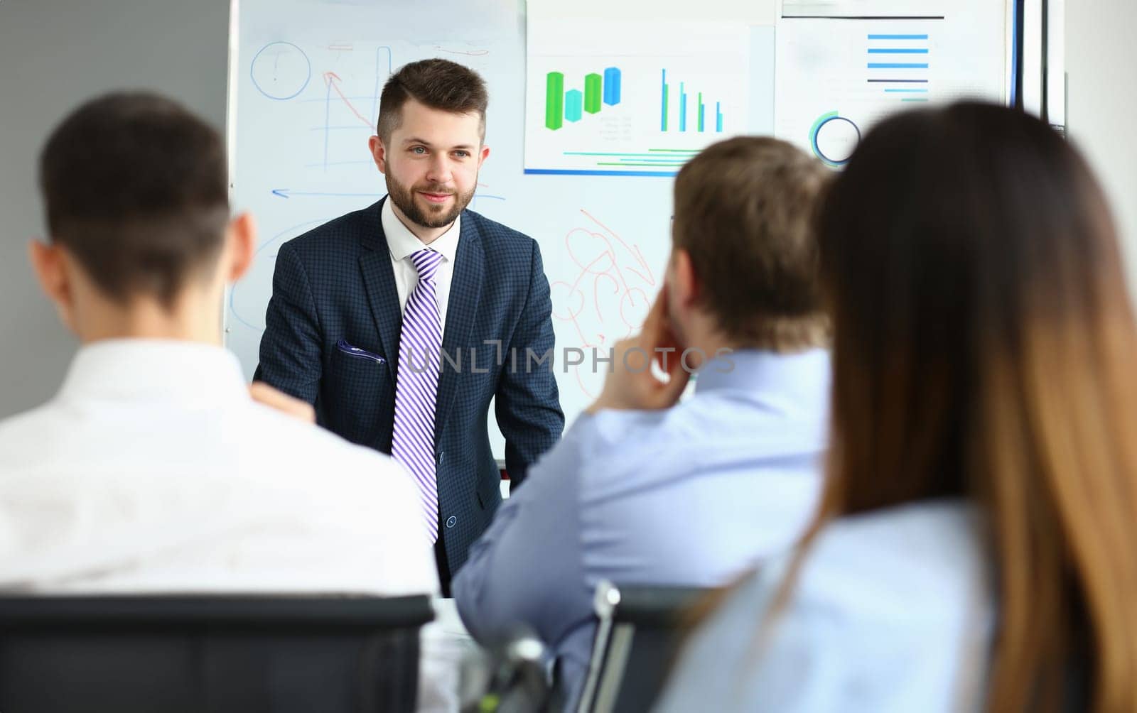 Portrait of handsome and cheerful person. Chief executive officer talking with business colleagues about new project. Worker sitting in conference room. Company and business meeting concept