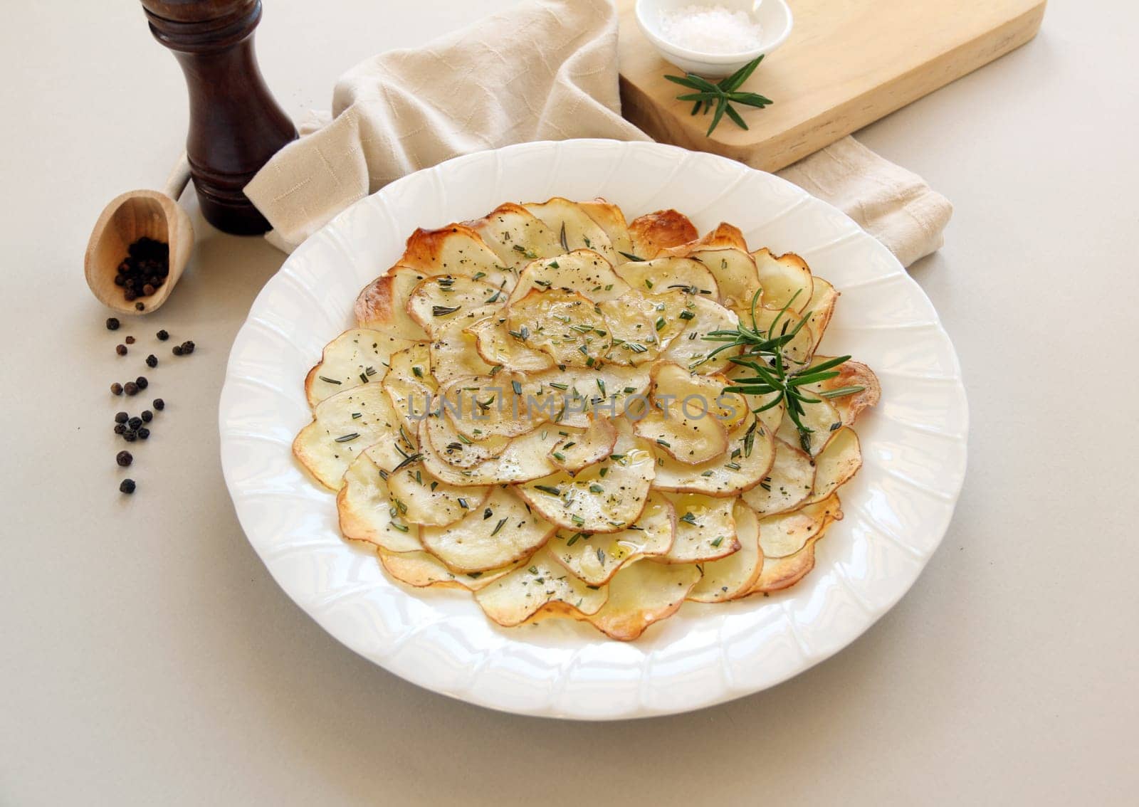 Delicious crispy baked potato chips with rosemary ready to serve.