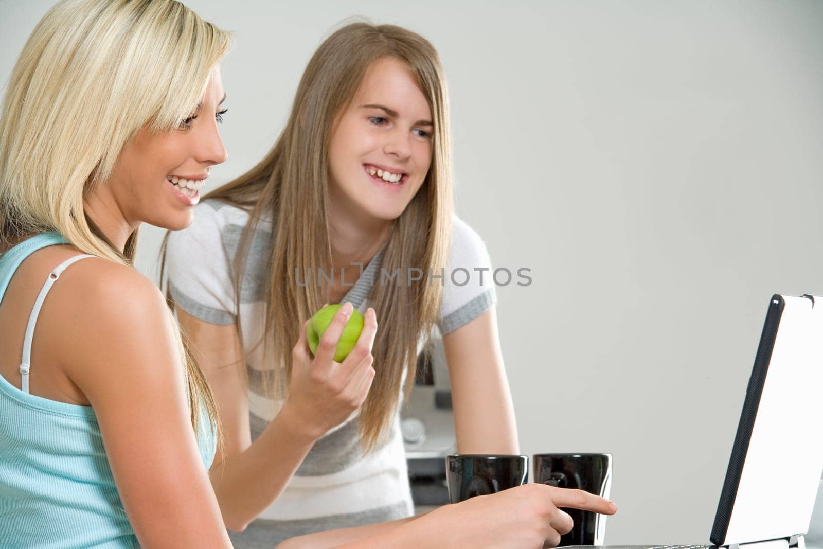 Two friends chatting and relaxing in the kitchen