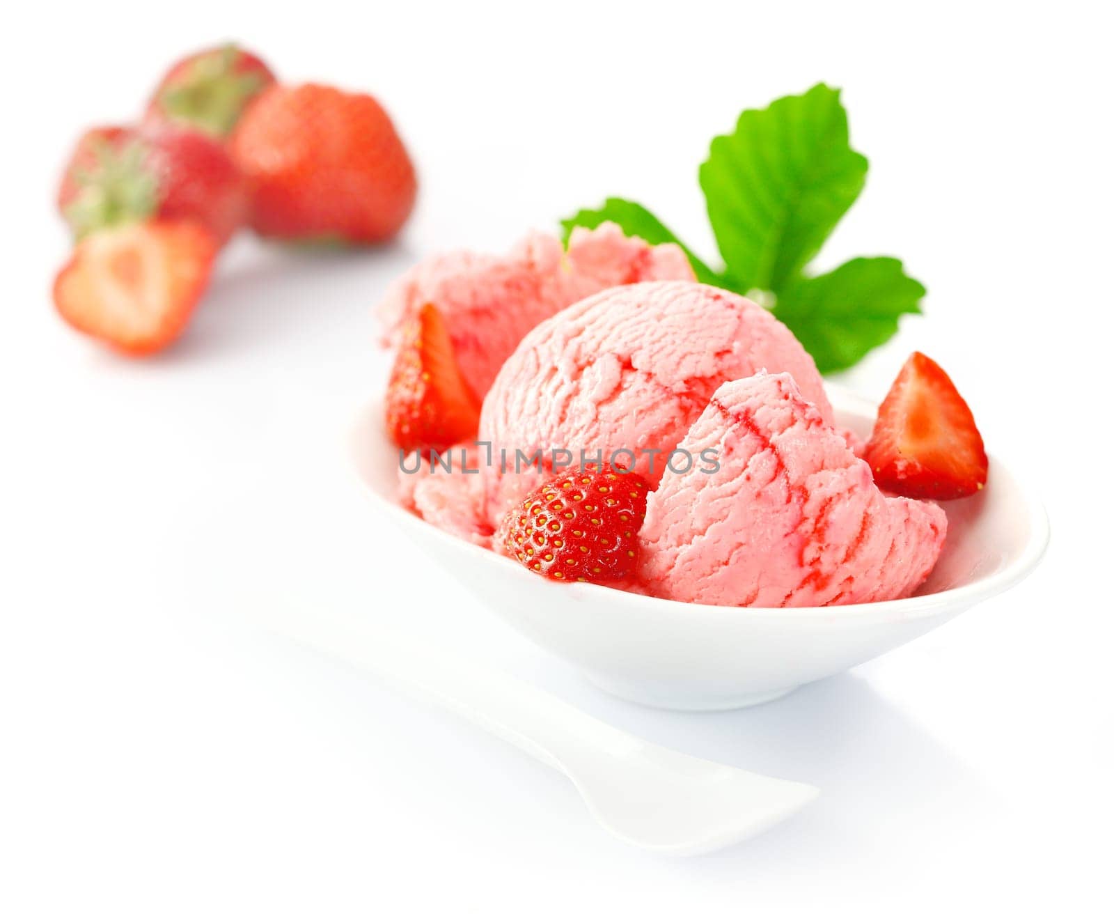 Serving od delicious piink strawberry Icecream and fresh diced strawberries served for dessert