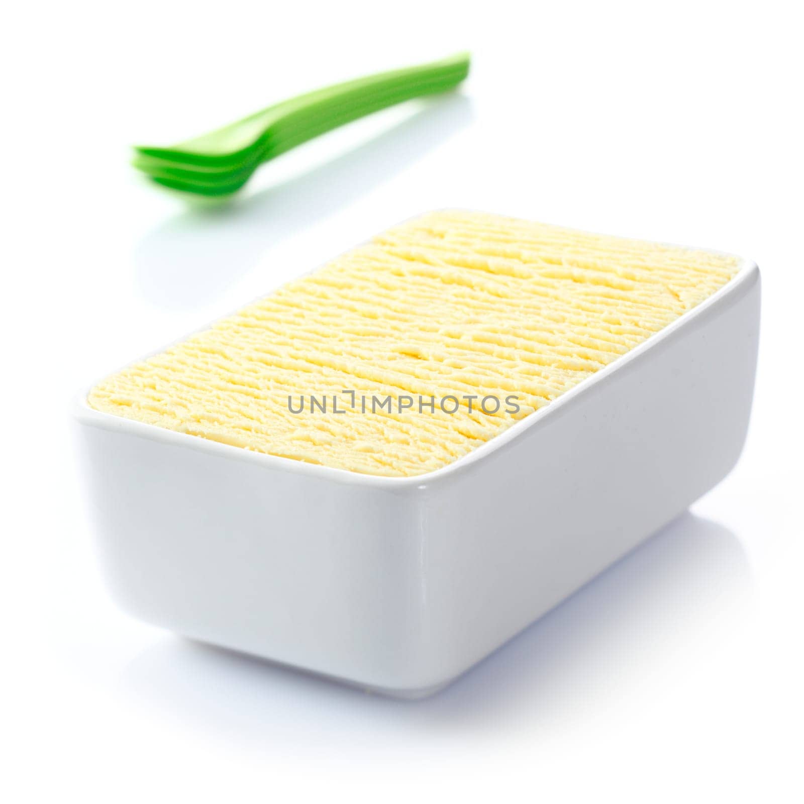 Ceramic tub filled with textured delicious frozen vanilla icecream ready to be served for dessert at a summertime meal