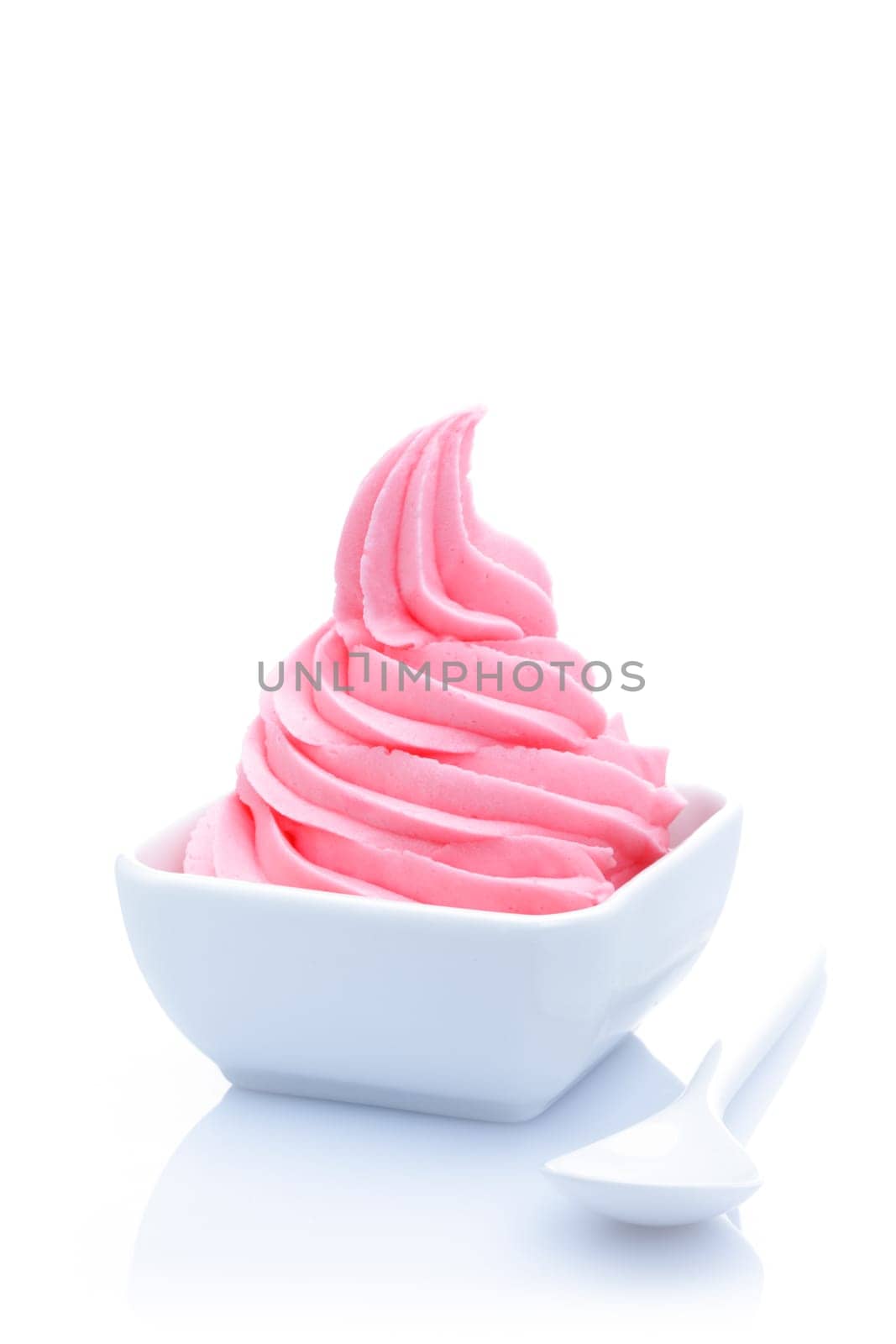 Twirled pink strawberry ice cream served as a refreshing dessert in a white porcelain dish
