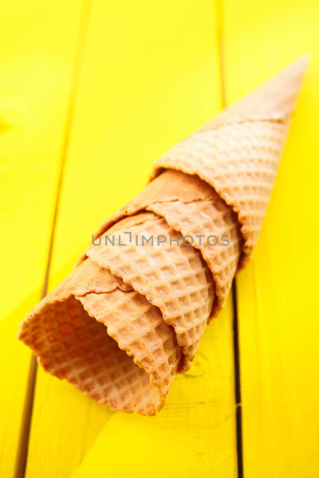 Close up shot of four Ice cream cones on yellow table