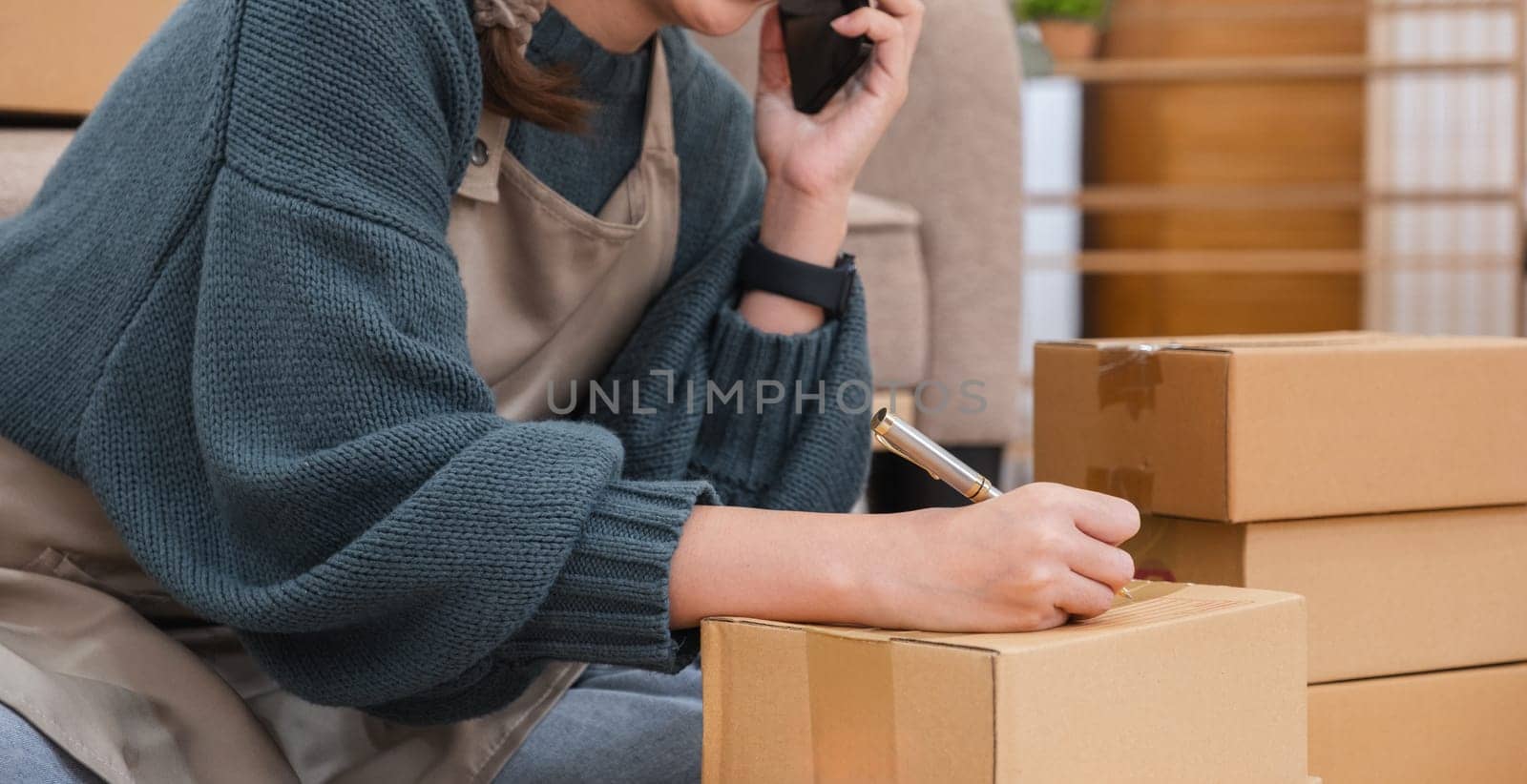 close up, Startup small business entrepreneur SME, asian woman packing cloth in box. Portrait young Asian small business owner home office, online sell marketing delivery.