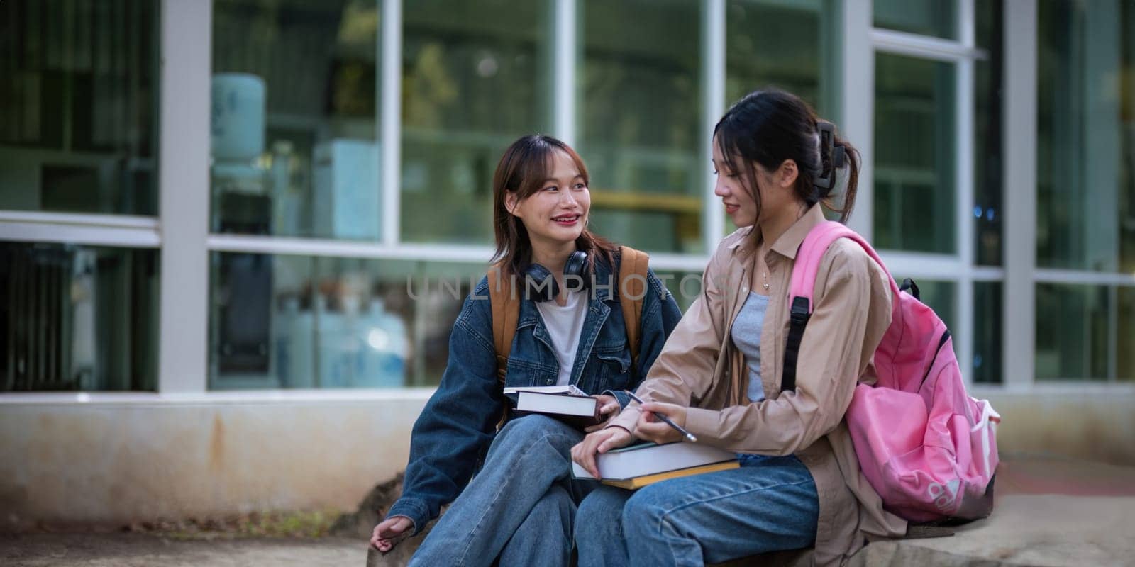 Happy young student chat with each other after class. Guy and girls wear casual clothes to study. Lifestyle College and University life concept, sincere emotions.