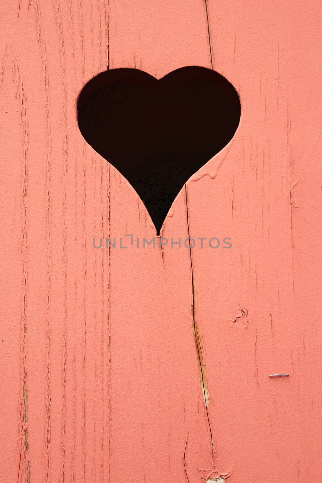 heart cut out in a wooden wooden wall