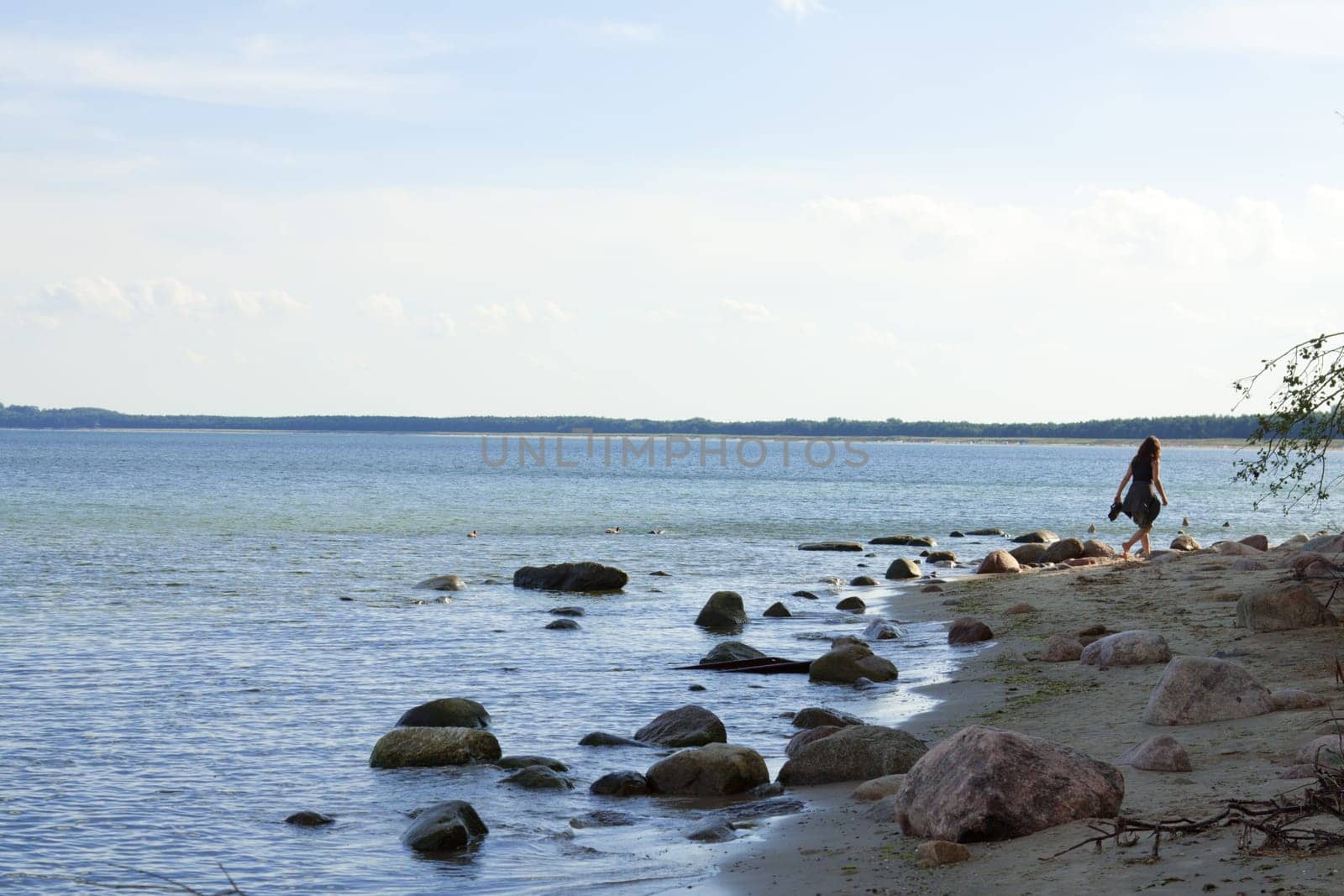 Girl on the beach with big stones