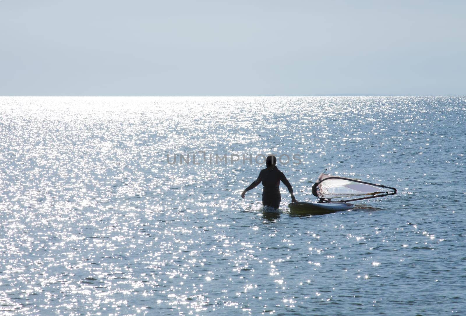 Surfer lands on the beach and pulls surfboard
