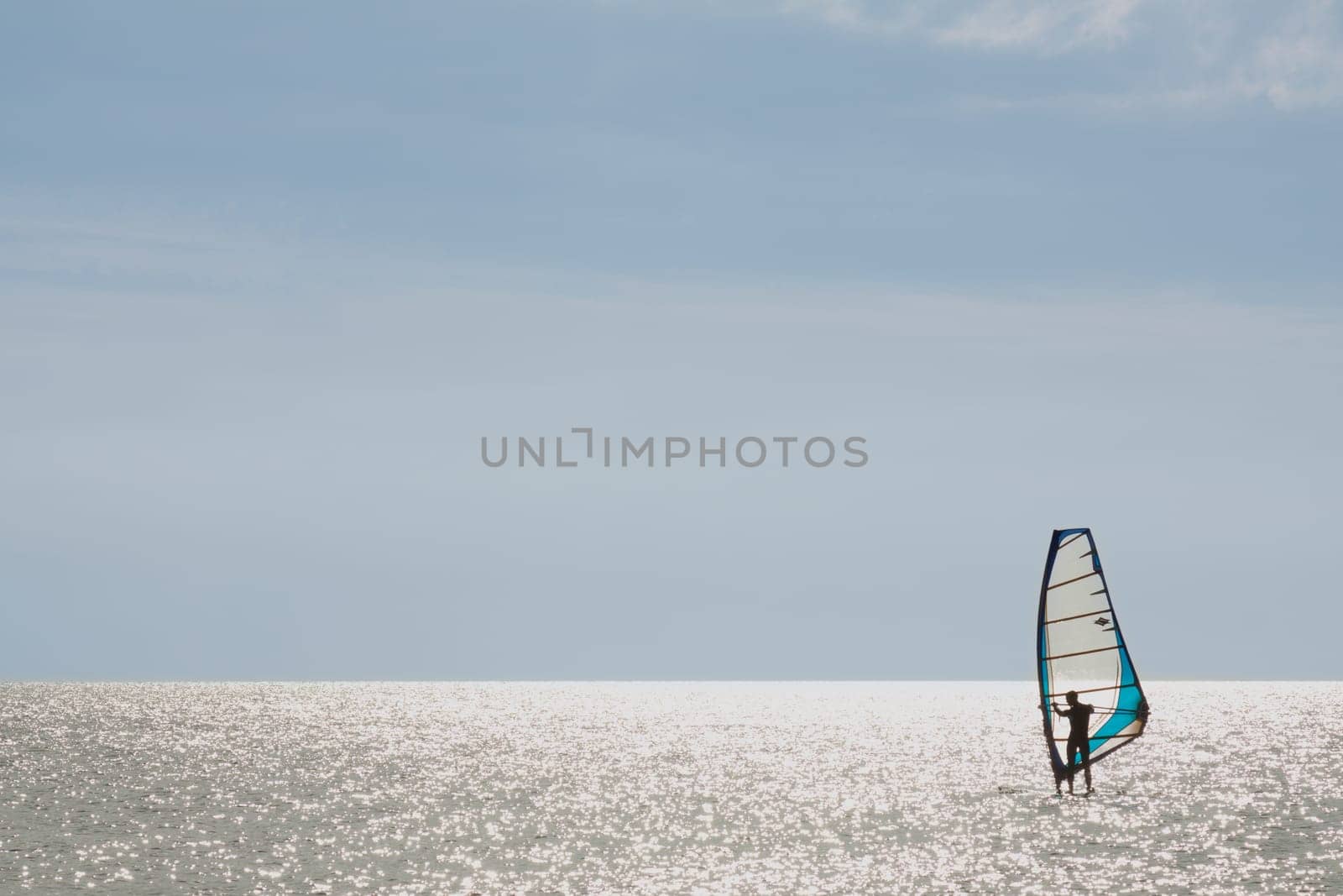 Surfer standing on his board in low wind